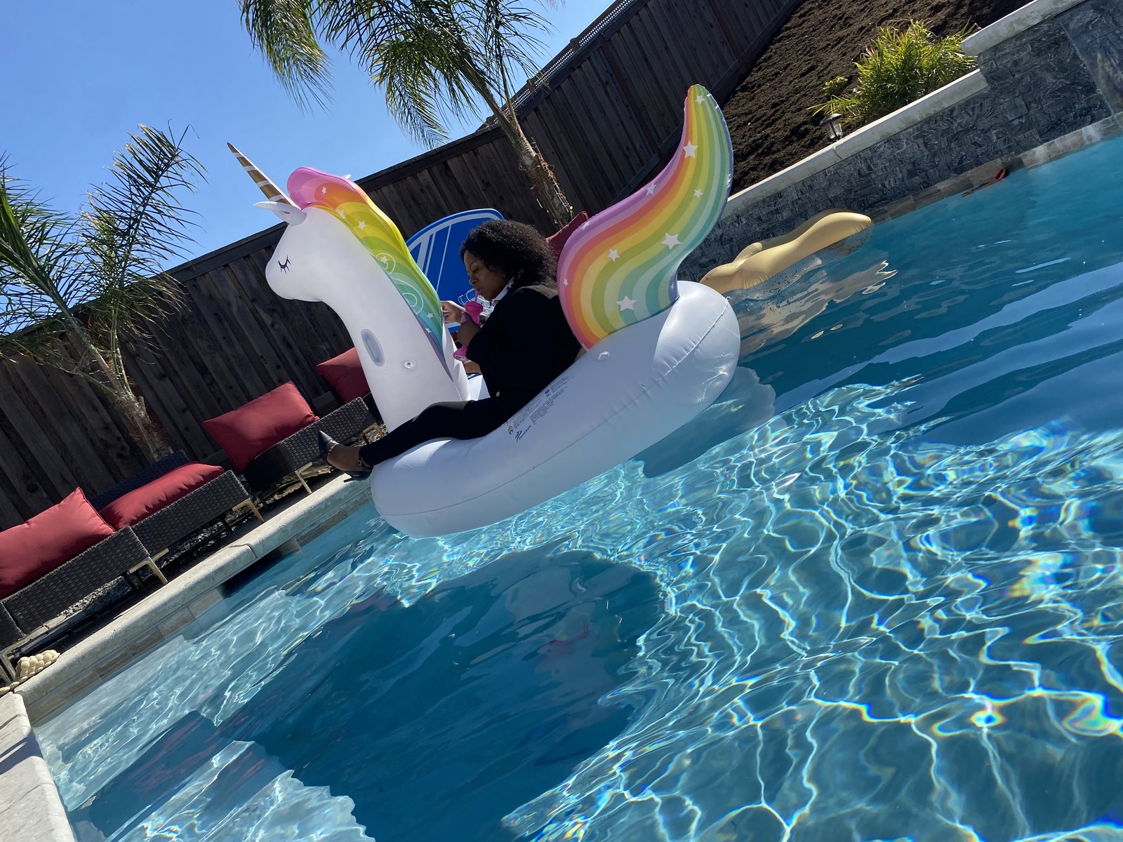 Michele on the float in a blazer and heels
