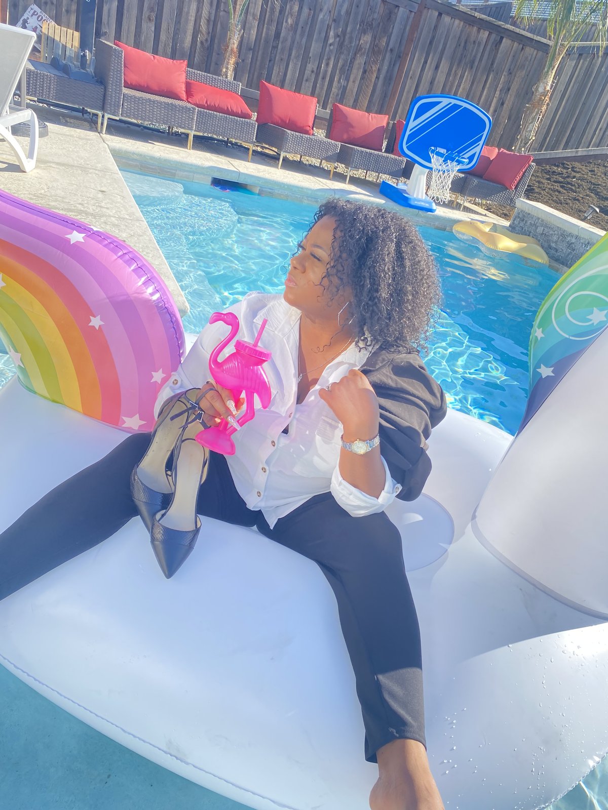 Michele Faith on a unicorn float, heels on