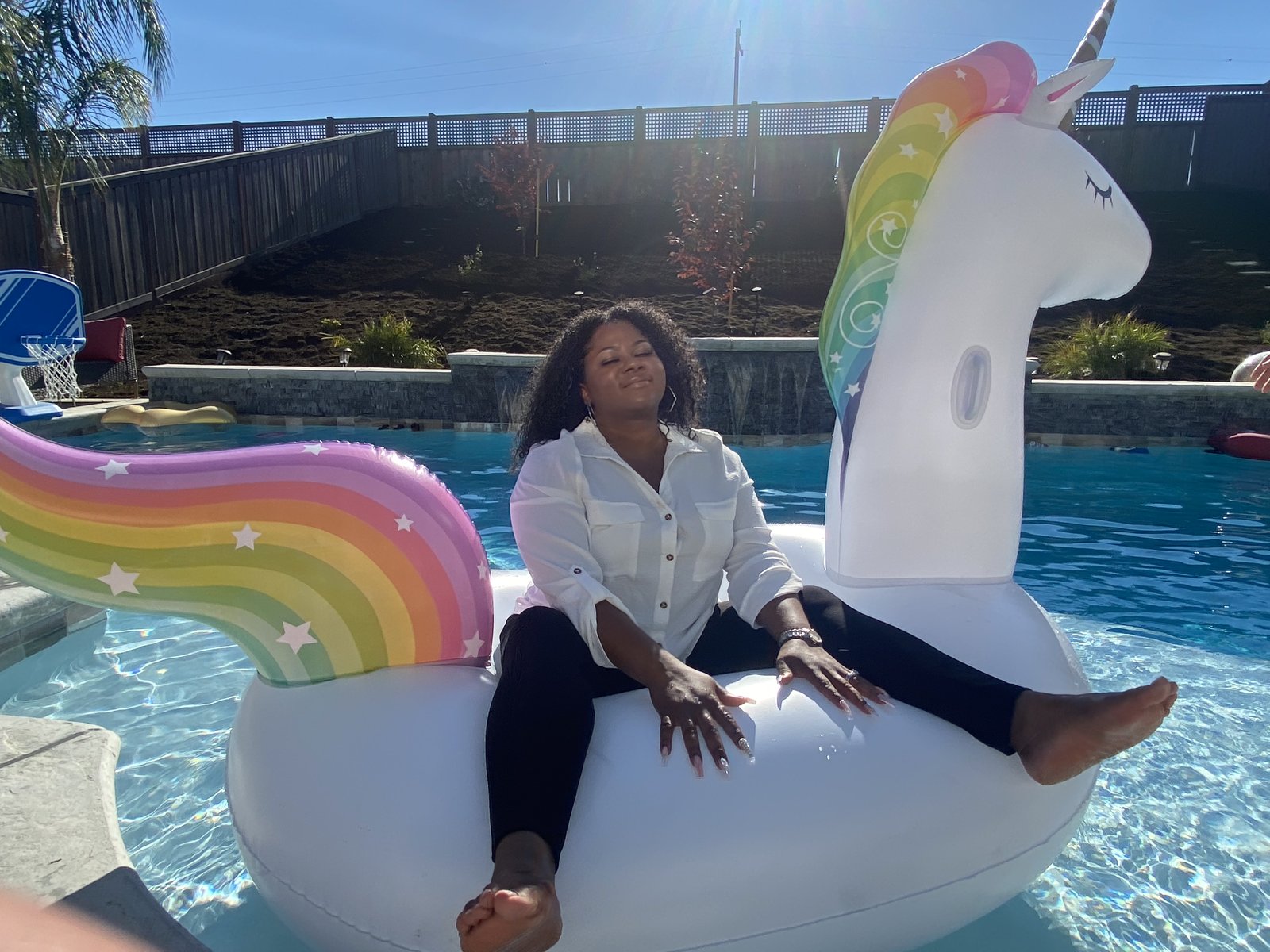 Michele sitting cross-legged on the float, eyes closed